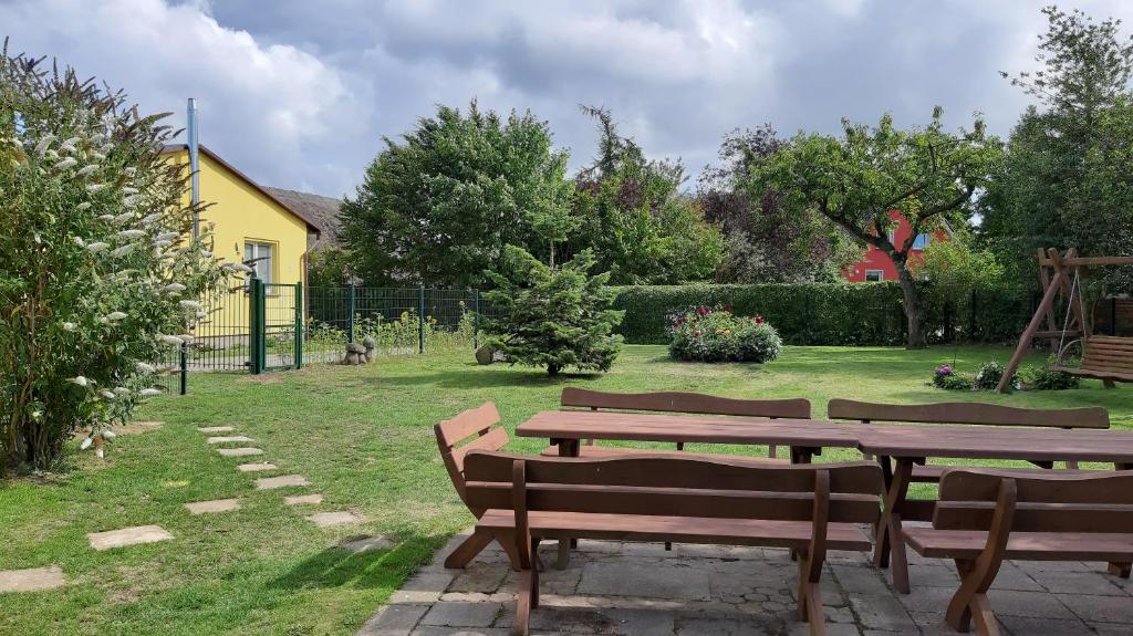洛默Ferienwohnung Smillenzweg mit Garten的院子里的野餐桌和长凳