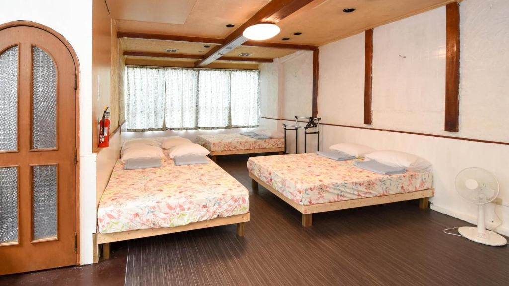 Siｍple Stay Makishi / Vacation STAY 43354客房内的一张或多张床位