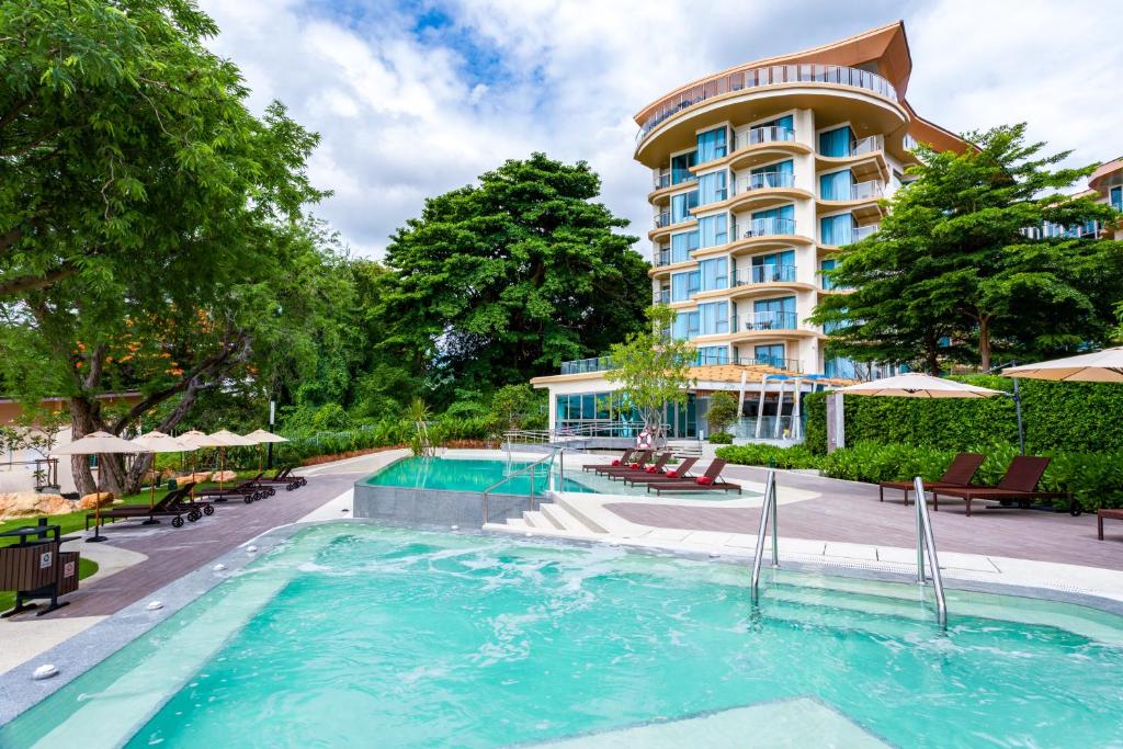 是拉差Centara Sonrisa Residences & Suites Sriracha的一座设有游泳池的酒店和一家酒店