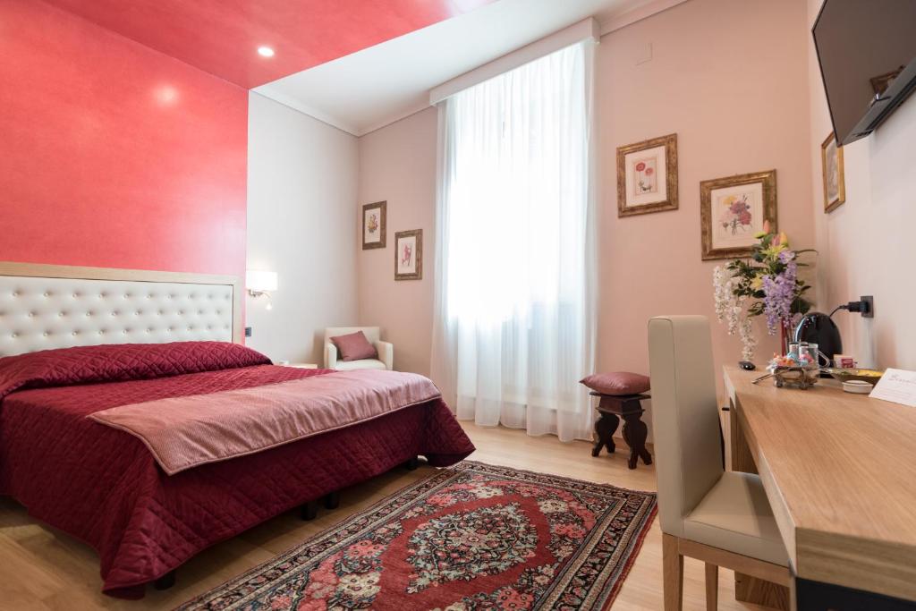 阿西西Brunelli B&B的一间卧室设有一张床和红色的墙壁