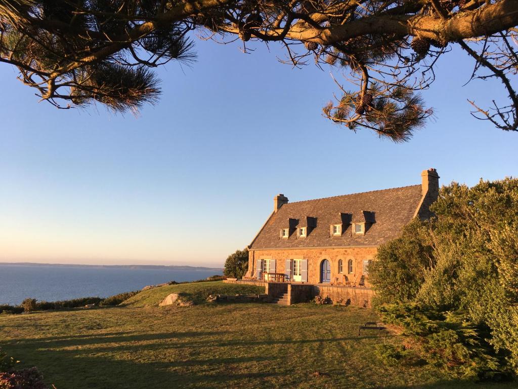 Poullan-sur-MerKerloulou的一座山丘上的房屋,背景是大海