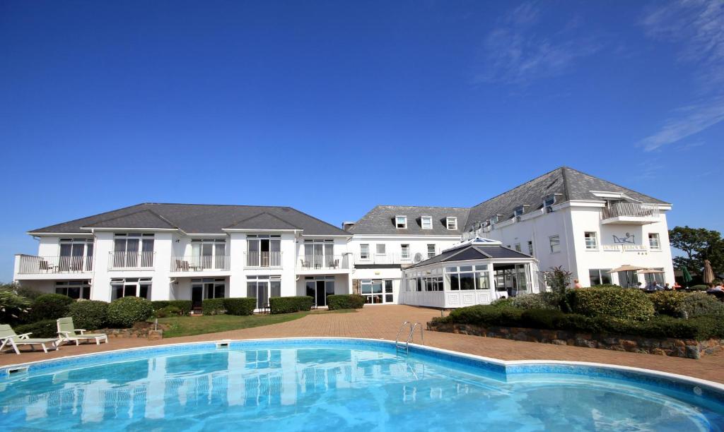圣彼得港杰尔博罗酒店的一座大房子,前面设有一个大型游泳池