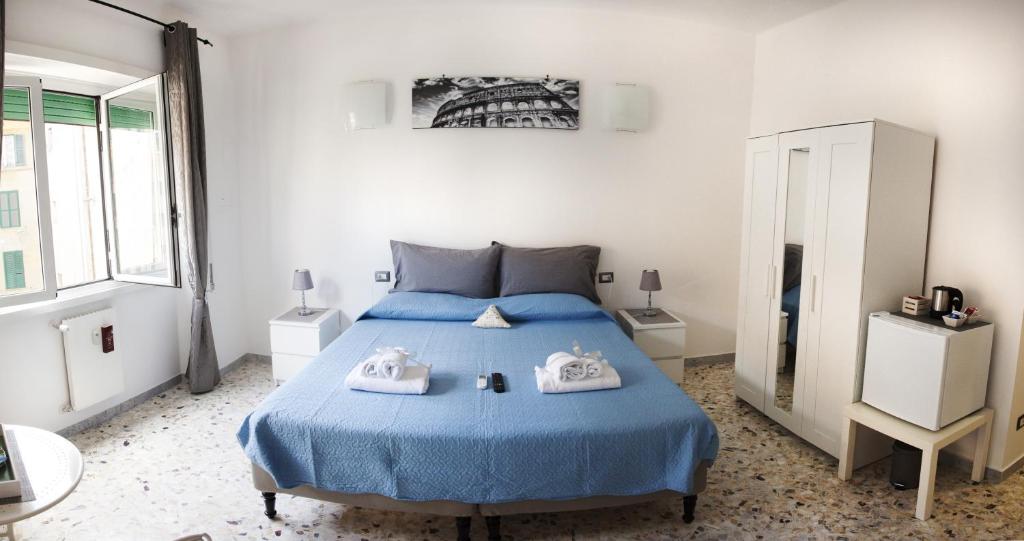 罗马Ostiense District B&B的一间卧室配有蓝色的床和毛巾