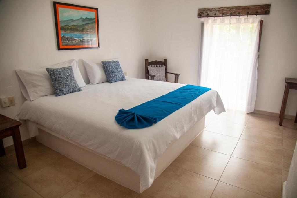 圣布拉斯La Familia的卧室配有一张大白色的蓝色床单