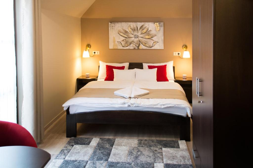 加尔多尼MeDoRa Park - Hotel MeDoRa***的一间卧室配有一张带红色枕头的大床