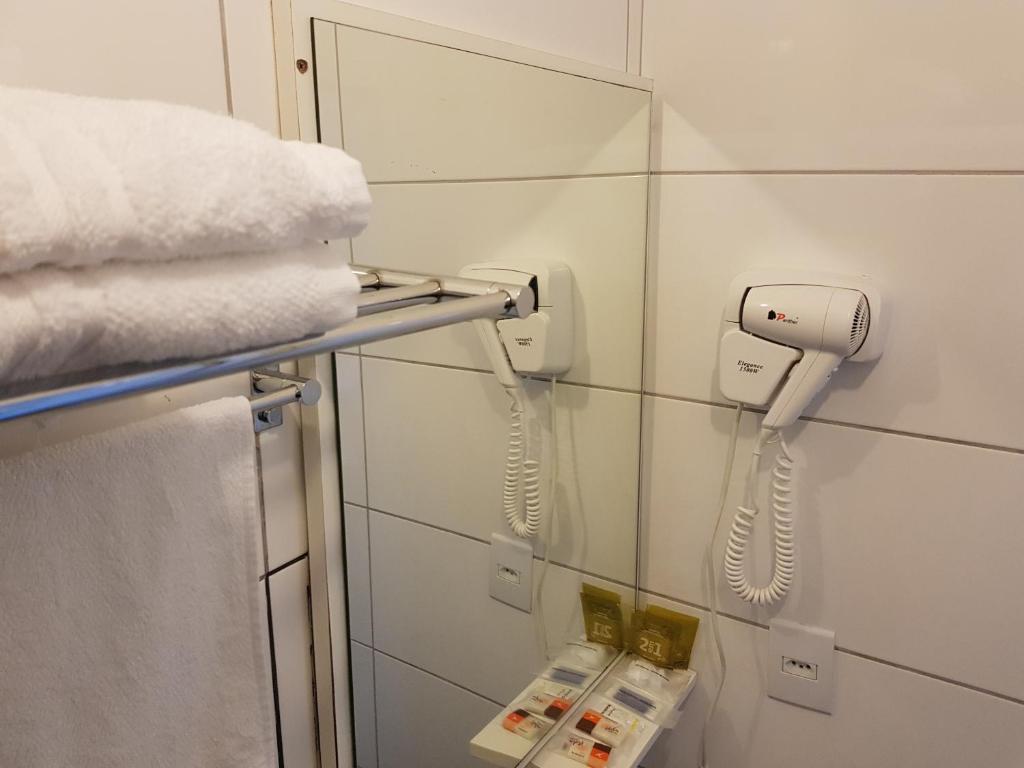 托雷斯郁金香酒店的浴室的墙上挂着电话