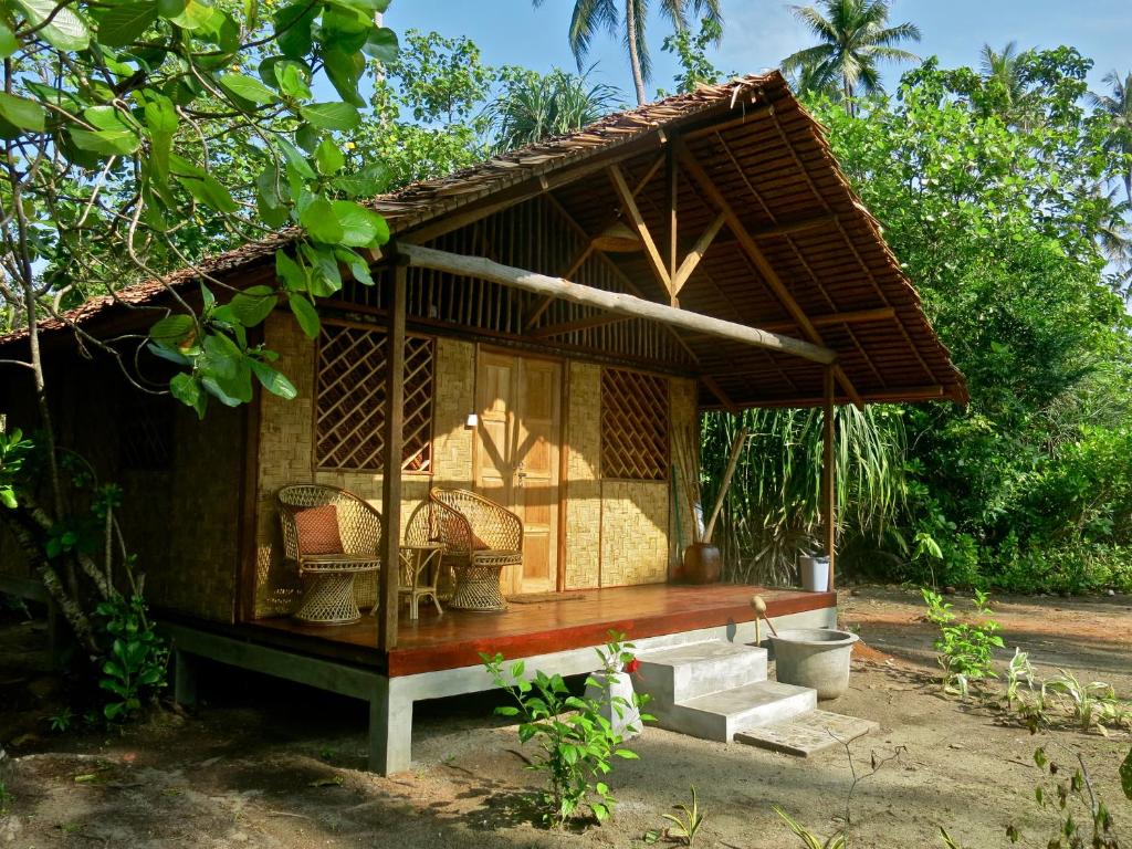 博拉科特Mutiara Beach Resort的花园中带长凳的小小屋