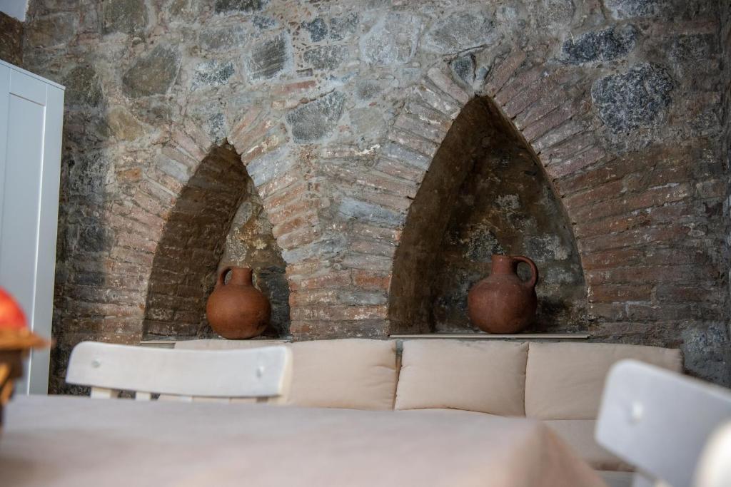 基佩朗达TO KONATZI TIS MAROULAS的墙上有两个砖炉,两瓶花