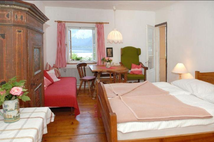 哈尔施塔特布劳伽斯特豪夫哈尔施塔特宾馆的一间卧室配有两张床和一张桌子及椅子