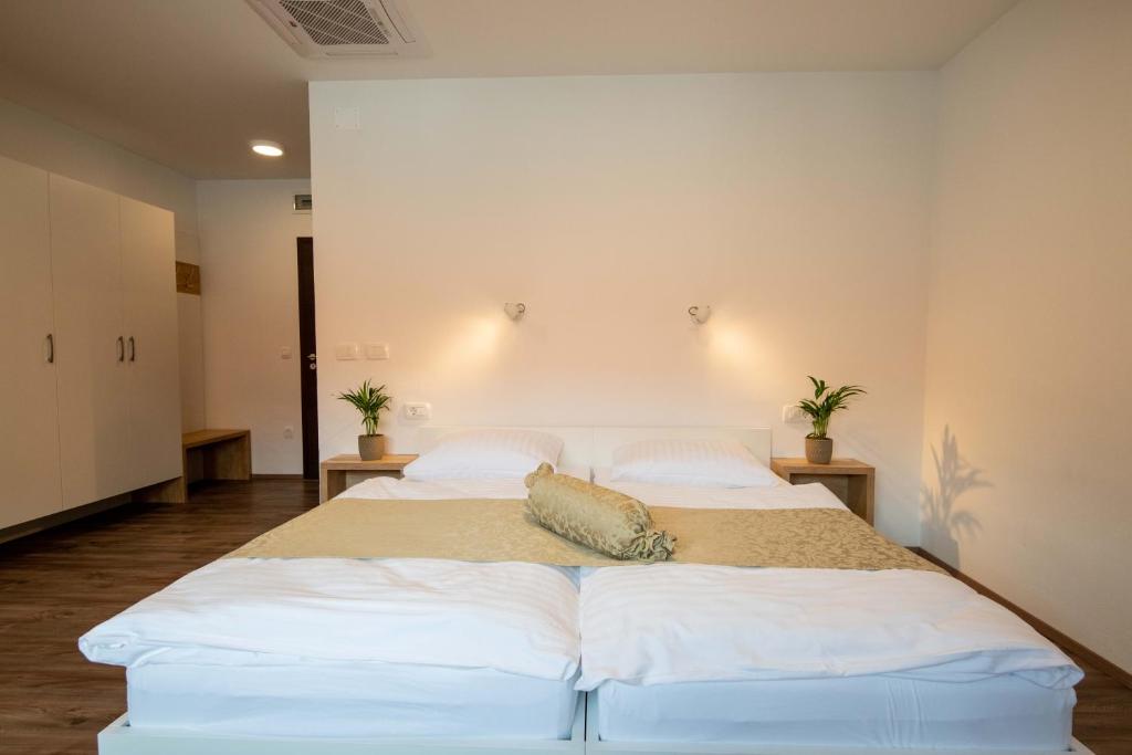 克拉尼Guesthouse Stari Mayr的一间卧室配有两张带白色床单和枕头的床。