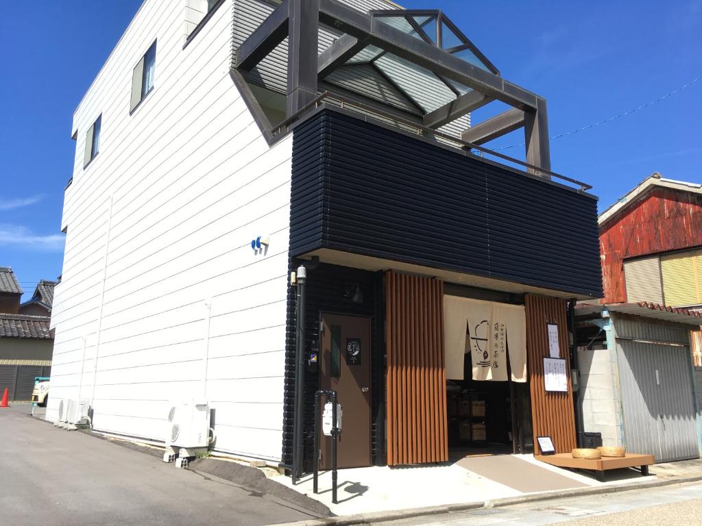 桑名市machiyado Kuwanajuku Kawaguchi-cho 8的黑白的建筑,黑屋顶