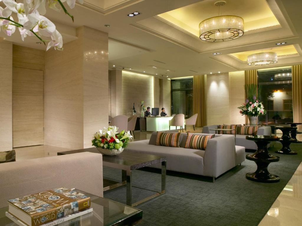 花莲市经典假日饭店的客厅配有沙发和桌子