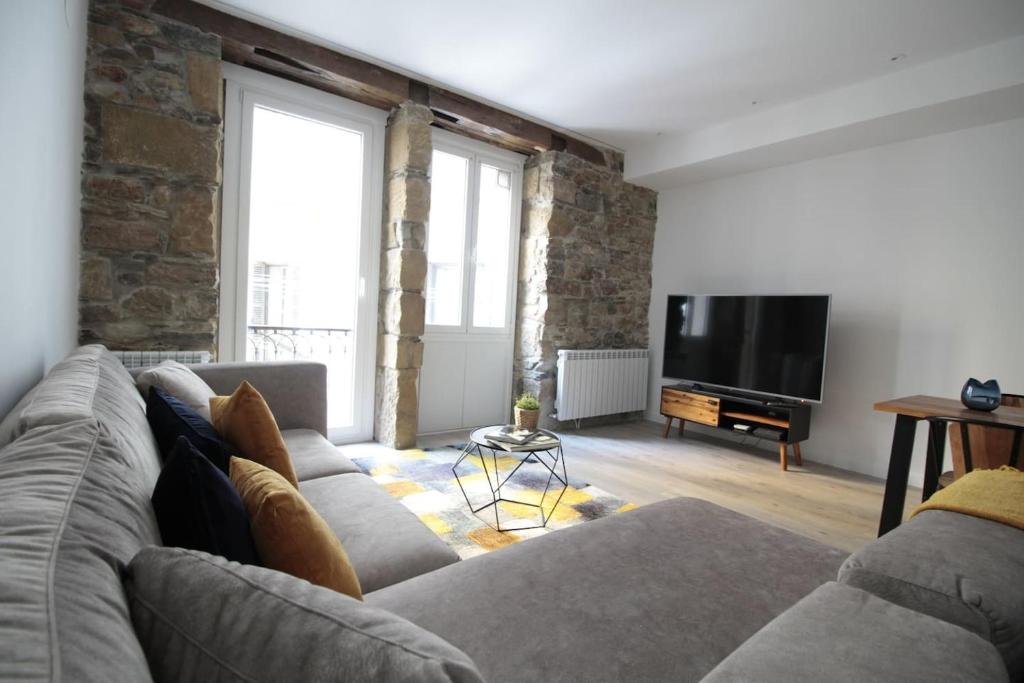 圣塞瓦斯蒂安SunSet Bastian Apartment的带沙发和平面电视的客厅