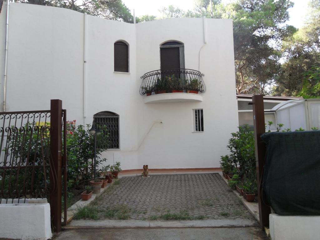 卡斯特拉巴特滨海Villa Zazzara的白色的房子,设有大门和阳台