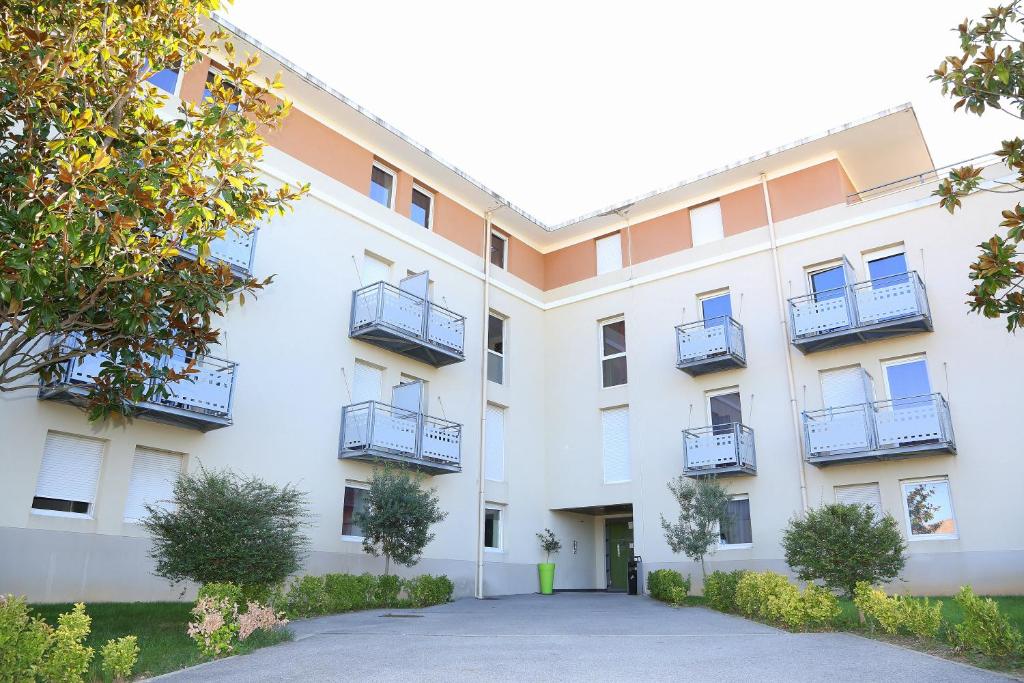 普罗旺斯艾克斯Résidence Les Académies Aixoise的公寓大楼设有阳台和车道。
