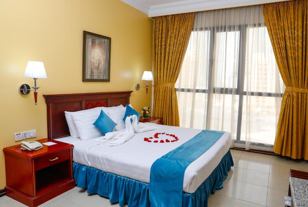 麦纳麦泰姬广场酒店的酒店客房,配有带毛巾的床
