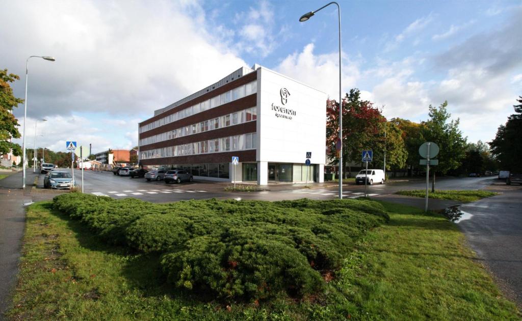 劳马Forenom Serviced Apartments Rauma Kaivopuisto的停车场前方的大建筑