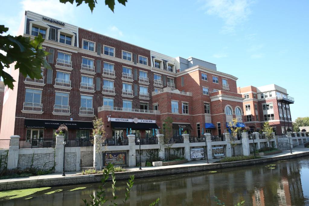 内珀维尔内珀维尔河滨因迪格酒店的河边的一座大型砖砌建筑
