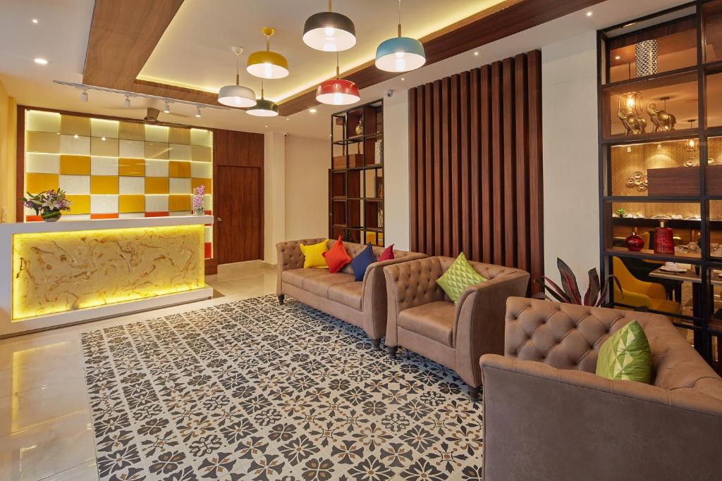 班加罗尔Regenta Inn Indiranagar by Royal Orchid Hotels的带沙发和地毯的客厅