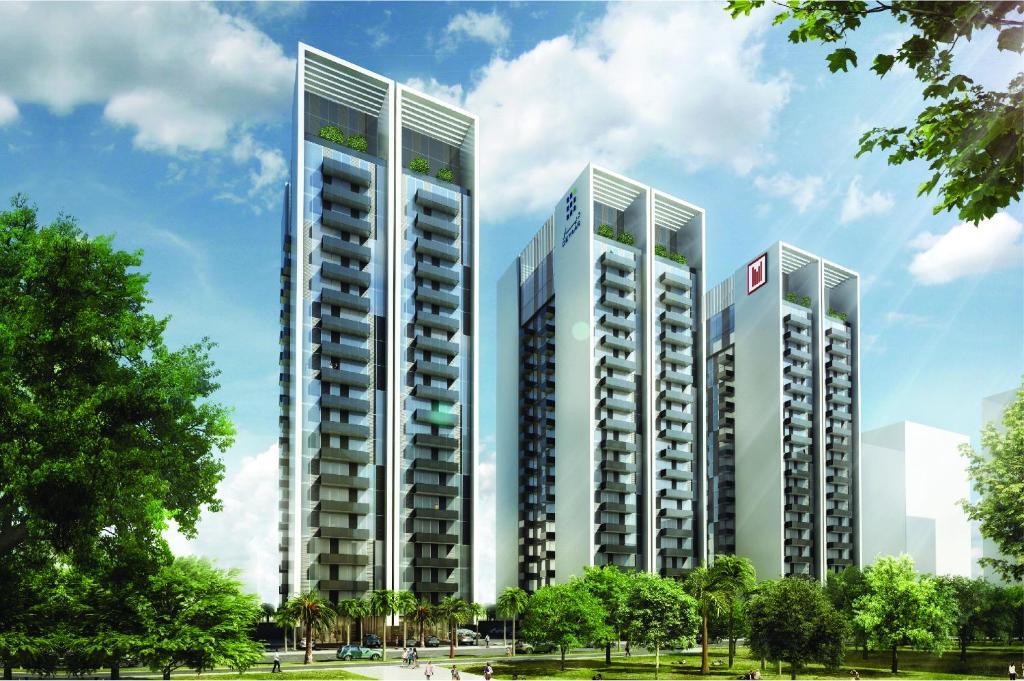 迪拜Millennium Executive Apartments Mont Rose的公园里三个高大的建筑的 ⁇ 染