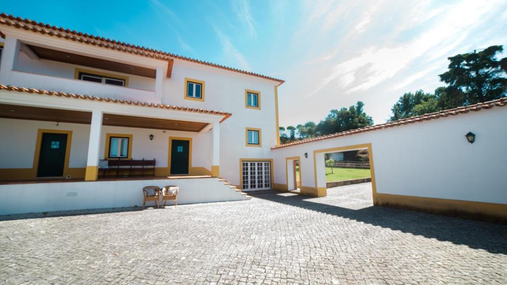 波亚里什新镇Quinta dos Lameiros的白色的房子,设有庭院和车道