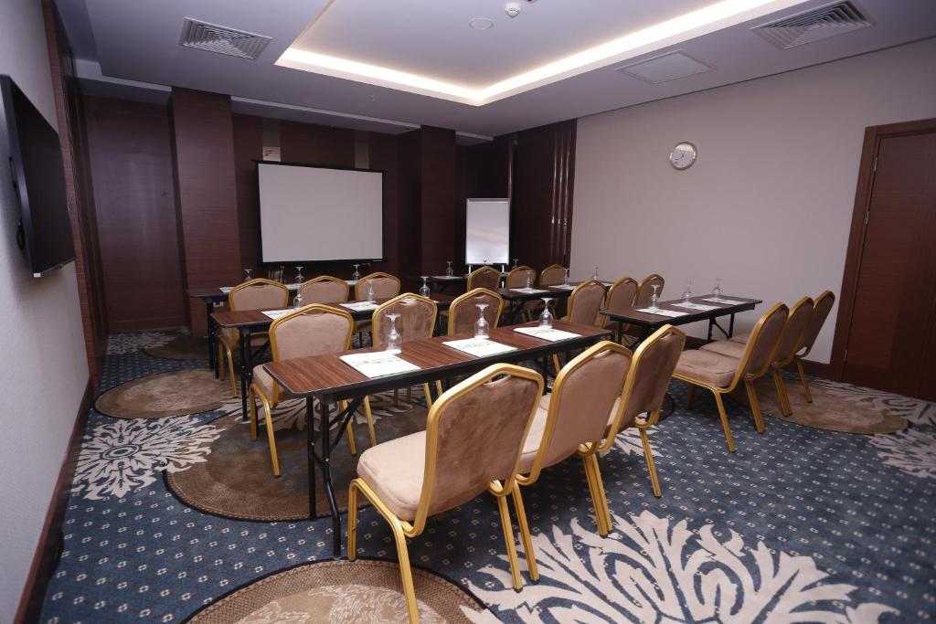 安卡拉安卡拉假日酒店 - 楚库兰巴尔的一间会议室,配有桌椅和屏幕