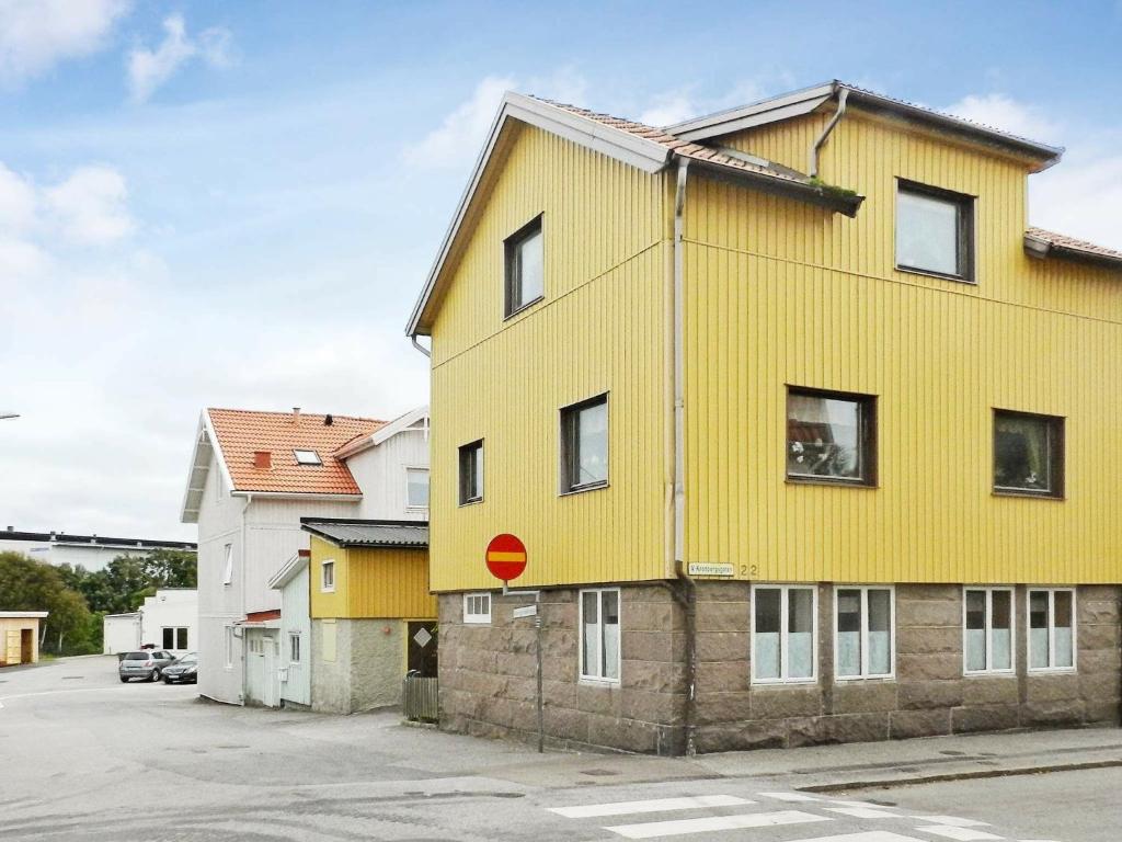 吕瑟希尔Holiday Home Västra IV的黄色的建筑,上面有红色的标志