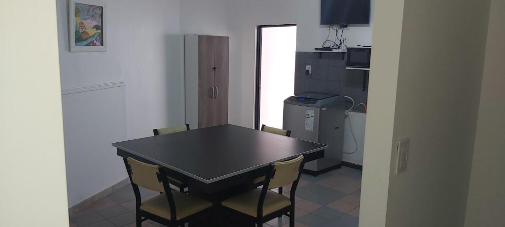拉里奥哈dpto centrico con oficina consultorio的厨房配有桌椅和冰箱。
