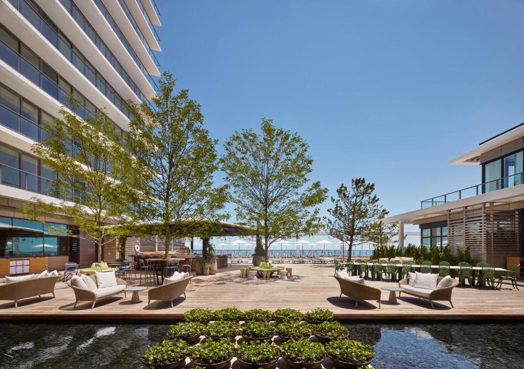 艾斯拜瑞Asbury Ocean Club Hotel的一座庭院,位于一座带椅子和树木的建筑中