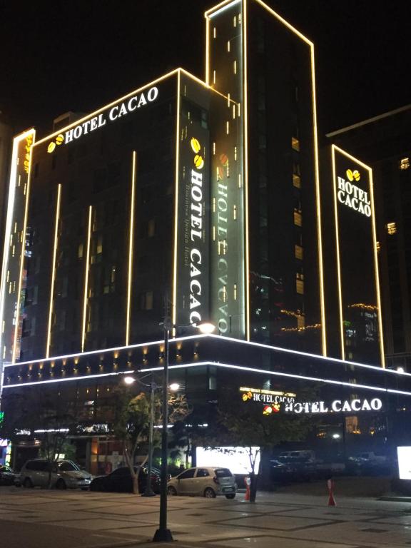 仁川市Sorae Hotel CACAO的一座大建筑,晚上有标志