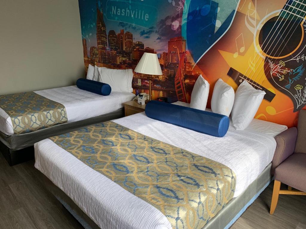 纳什维尔Ramada by Wyndham Nashville/Music Valley的酒店客房设有两张床和吉他墙