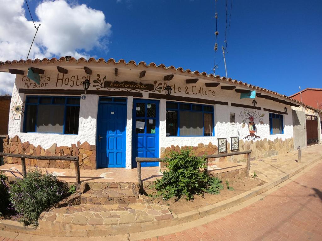 萨迈帕塔Andoriña Hostal - Bed & Breakfast的街道上设有蓝色门的建筑