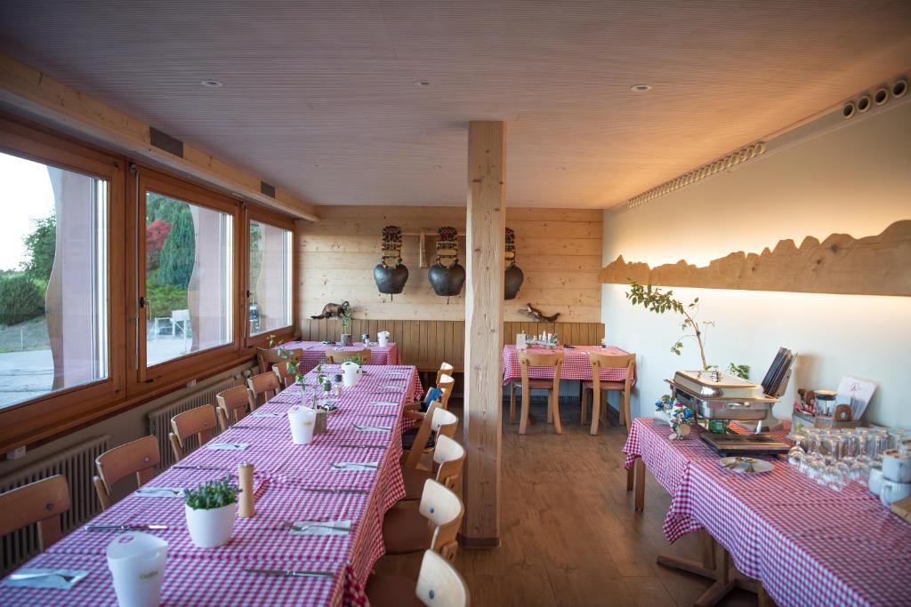 GanterschwilRestaurant und Kaeserei Berghof的配有桌椅和粉红色桌布的房间