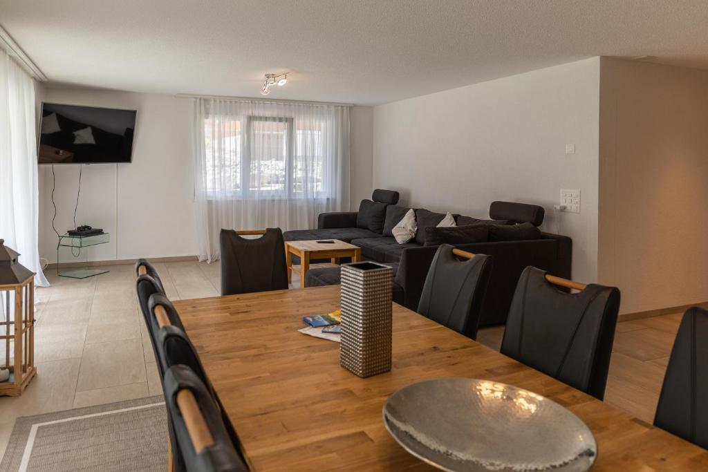 维尔德斯韦尔Chalet Gousweid- Mönch Apartment的客厅配有桌子和沙发