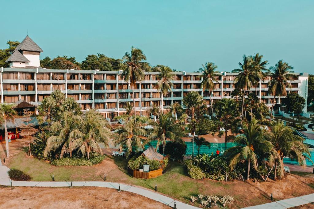 迪沙鲁Tunamaya Beach & Spa Resort- Desaru的享有棕榈树和游泳池度假村的空中景致