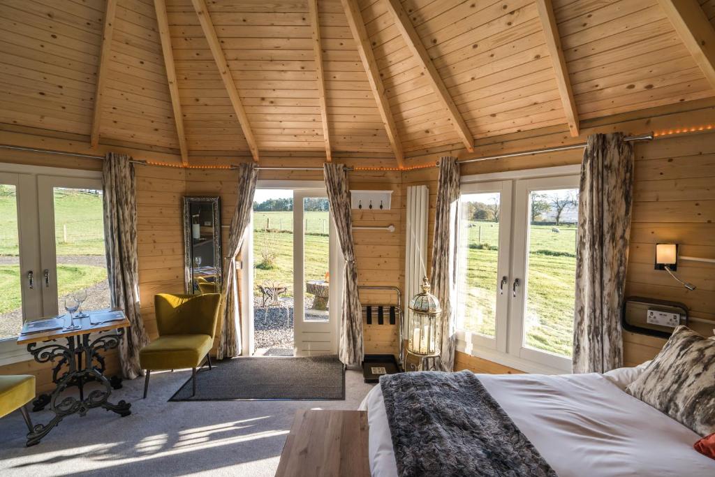 德里门Dunroamin Lodges的卧室配有一张床、一张书桌和窗户。