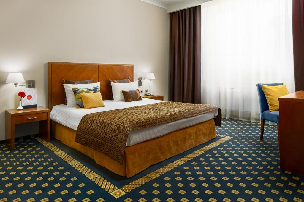 叶卡捷琳堡乌斯塔莫斯科夫斯卡亚格尔卡酒店的配有一张床和一把椅子的酒店客房