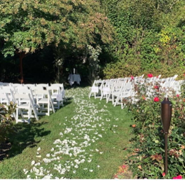 布里奇汉普顿Bridgehampton Inn的花田里一排白色椅子