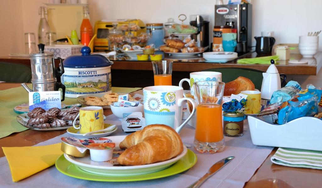 那不勒斯B&B Galileo的一张桌子,早餐包括羊角面包和橙汁