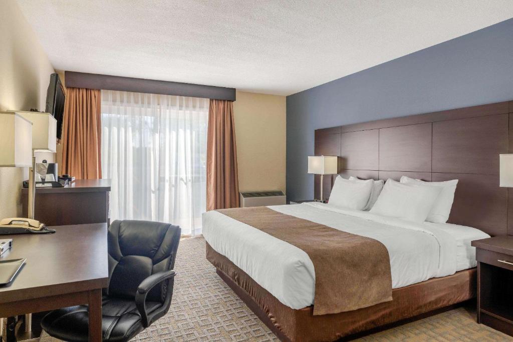 巴瑟斯特品质酒店的酒店客房设有一张大床和一张书桌。