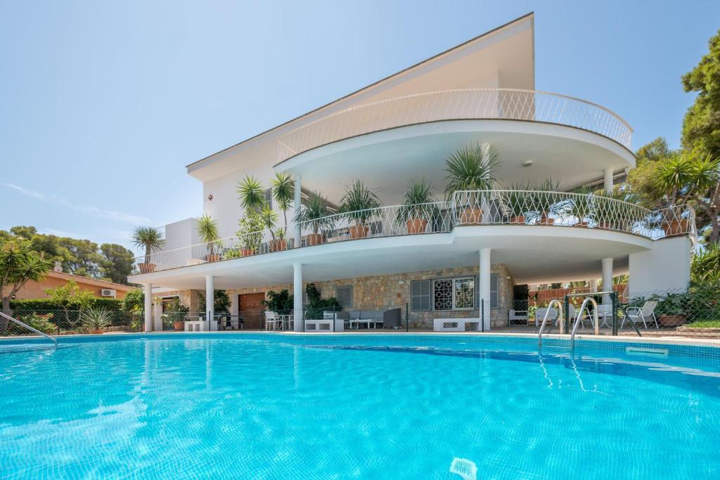 埃尔阿雷纳尔Villa Son Veri de la Marina的一座别墅,在一座建筑前设有一个游泳池