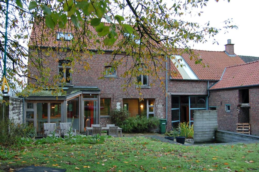 赫拉尔兹贝亨Vakantiehuis Lazy house的院子里带椅子的砖屋