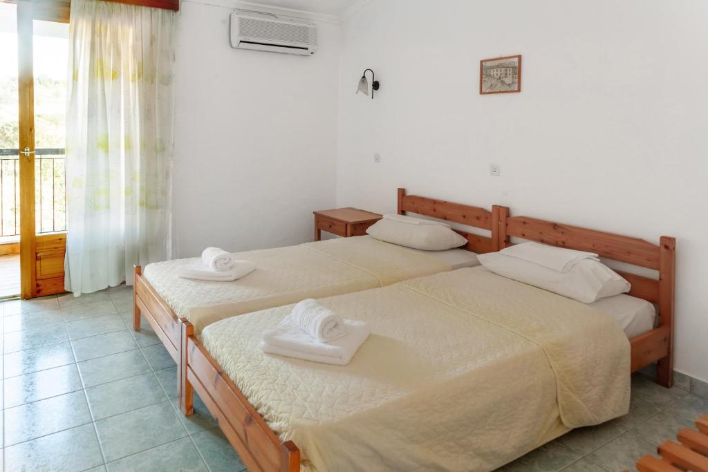 KamariotissaAeolos Hotel的带窗户的客房内设有两张单人床。