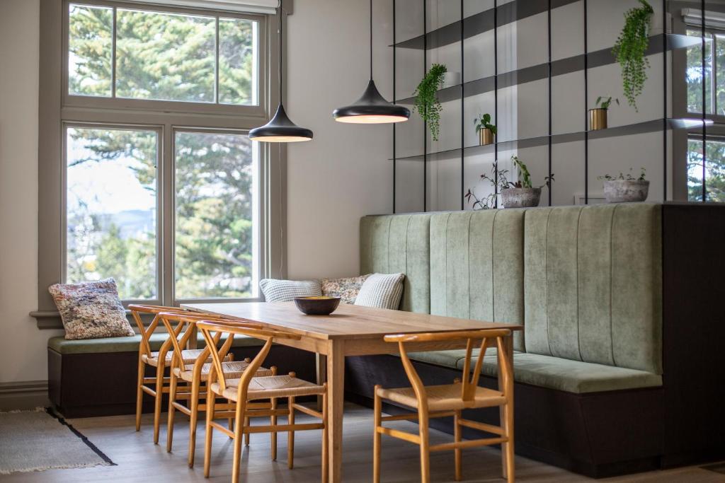 但尼丁The Burlington Luxury Octagon Apartment的一间带木桌和椅子的用餐室