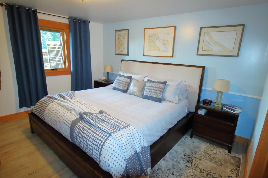 Salt Spring IslandMossy Hill Suite的一间卧室配有一张带蓝色墙壁的大床