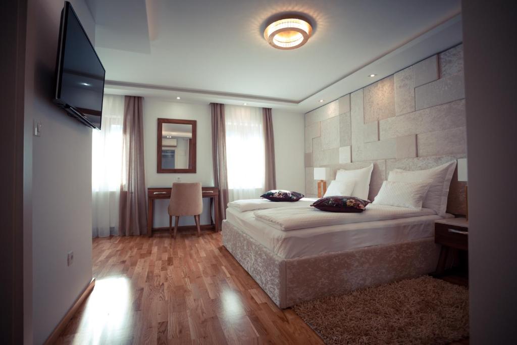 普利特维采湖Grand Lakes 2的酒店客房,配有床和电视