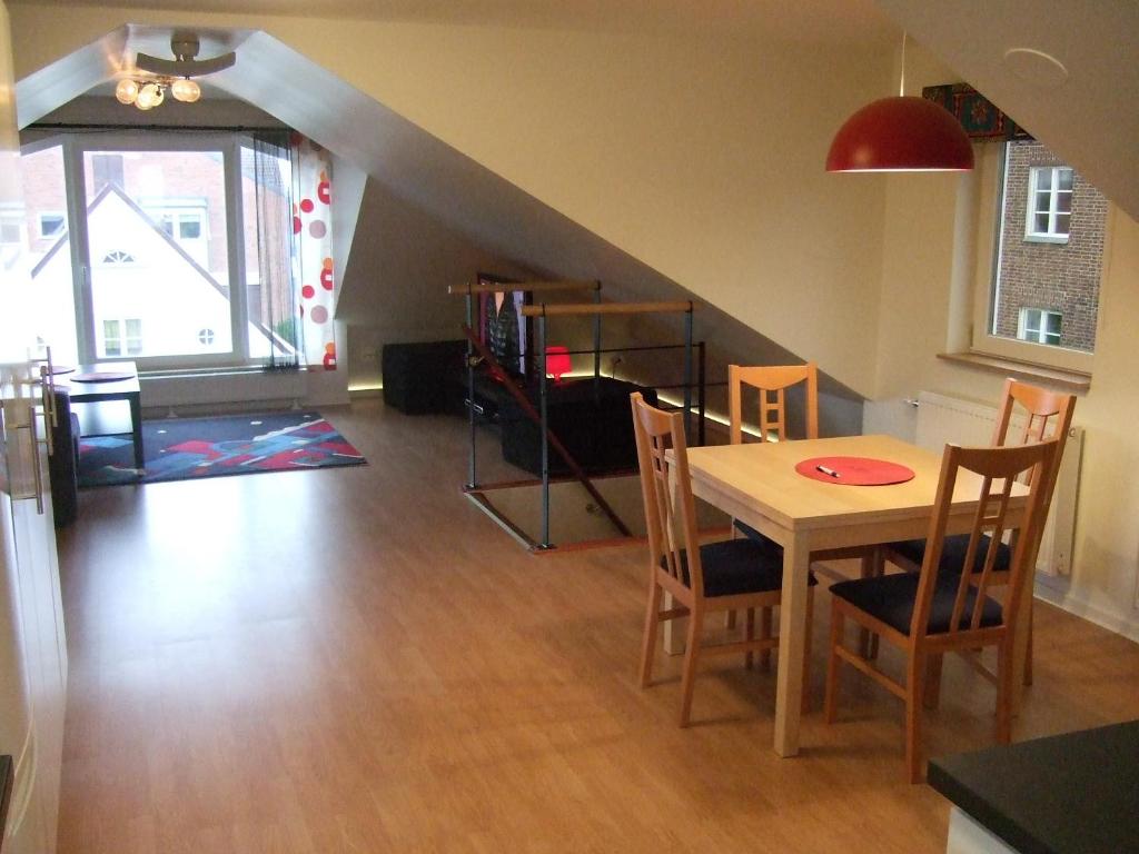 赫尔辛堡蜜月海景公寓酒店的一间带桌椅和楼梯的客厅