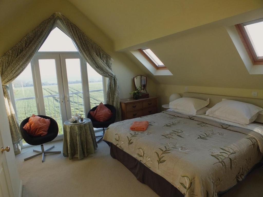 埃文河畔布拉德福Herb Cottage的一间卧室设有一张床和一个大窗户