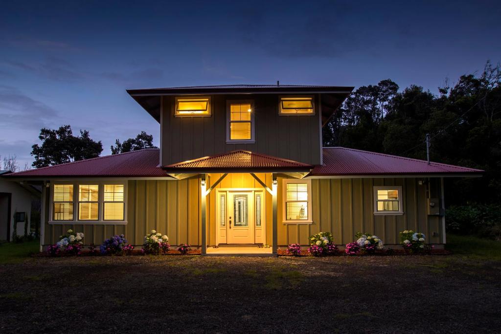 沃尔卡诺Kilauea House的一座黄色门和灯的房子