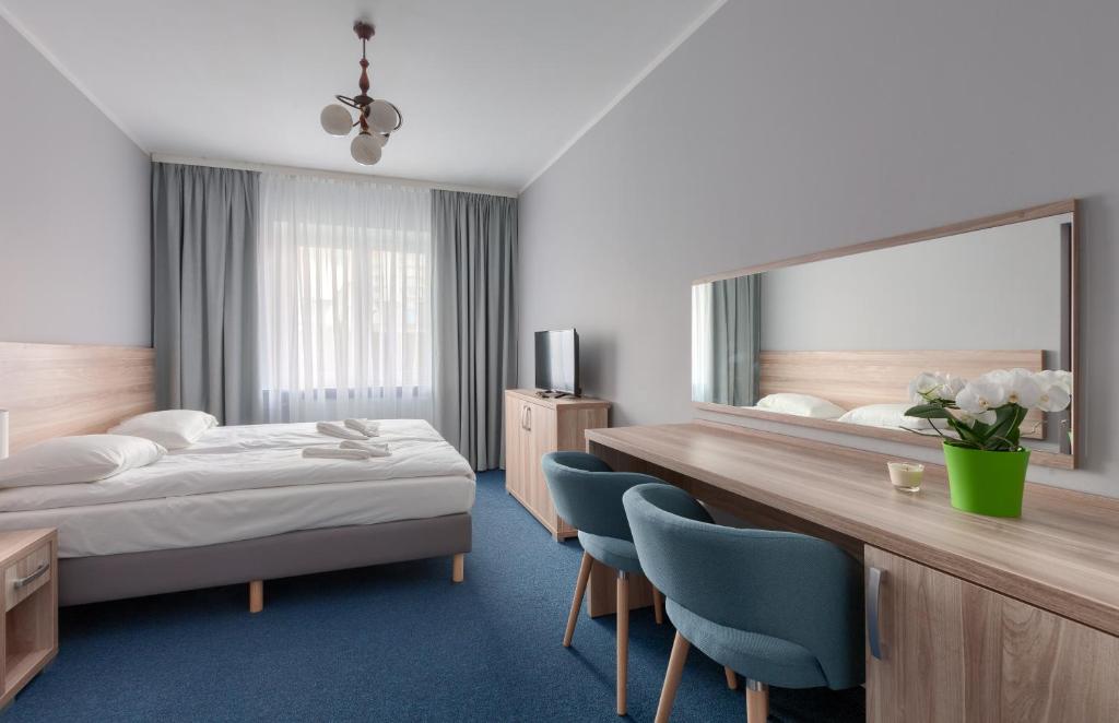 米兹多洛杰波塞冬旅舍的酒店客房设有一张床和一面大镜子